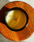 Candle in a wooden holder on a textured surface