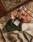 Journals and a jar on a floral-patterned surface