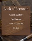text listing the scent notes in Book of Brennan candle with background of old leather-bound journal, glasses, and fountain pen