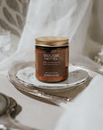 Bougie Hotel candle on a silver tray with white flowers in the background