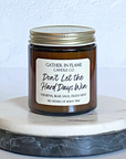 A coconut wax candle jar with a label that reads 'Don't Let the Hard Days Win', placed on a marble surface, with a white background and a gold lid on top.