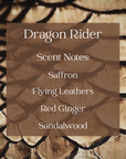 Text with scent notes of dragon rider candle with a background of gold dragon scales