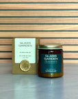 Glass Garden candle and packaging on a wooden surface