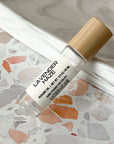 perfume roller labeled Lavender Haze on a terrazzo surface