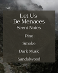 text with the scent notes of the Let Us Be Menaces candle with a foggy mountain range in the background
