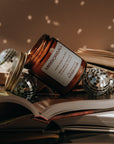 Jar of Mirrorball on an open book with decorative items