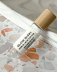 perfume roller labeled Slow Burn on a terrazzo surface
