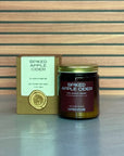 Spiked Apple Cider candle with packaging on a wooden surface