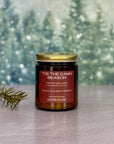 Candle jar labeled 'Tis the Damn Season with a festive background