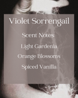 Text with the scent notes of the violet sorrengail candle with background of hands channeling lightening