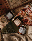 Three small jars with labels on a floral-patterned surface