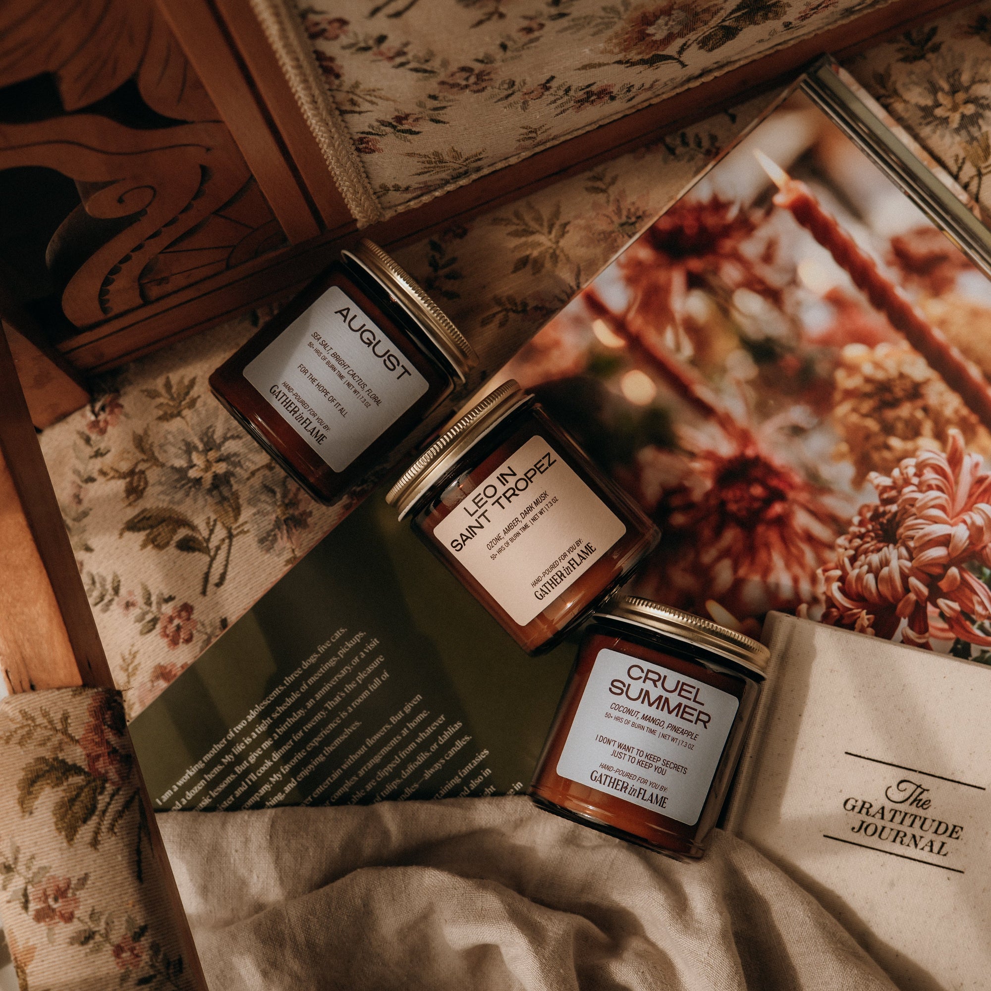 Three small jars with labels on a floral-patterned surface