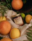 Jar of 'Sugared Citrus' with lemons and oranges on a textured fabric background