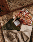 Product on a floral-patterned surface with a magazine underneath
