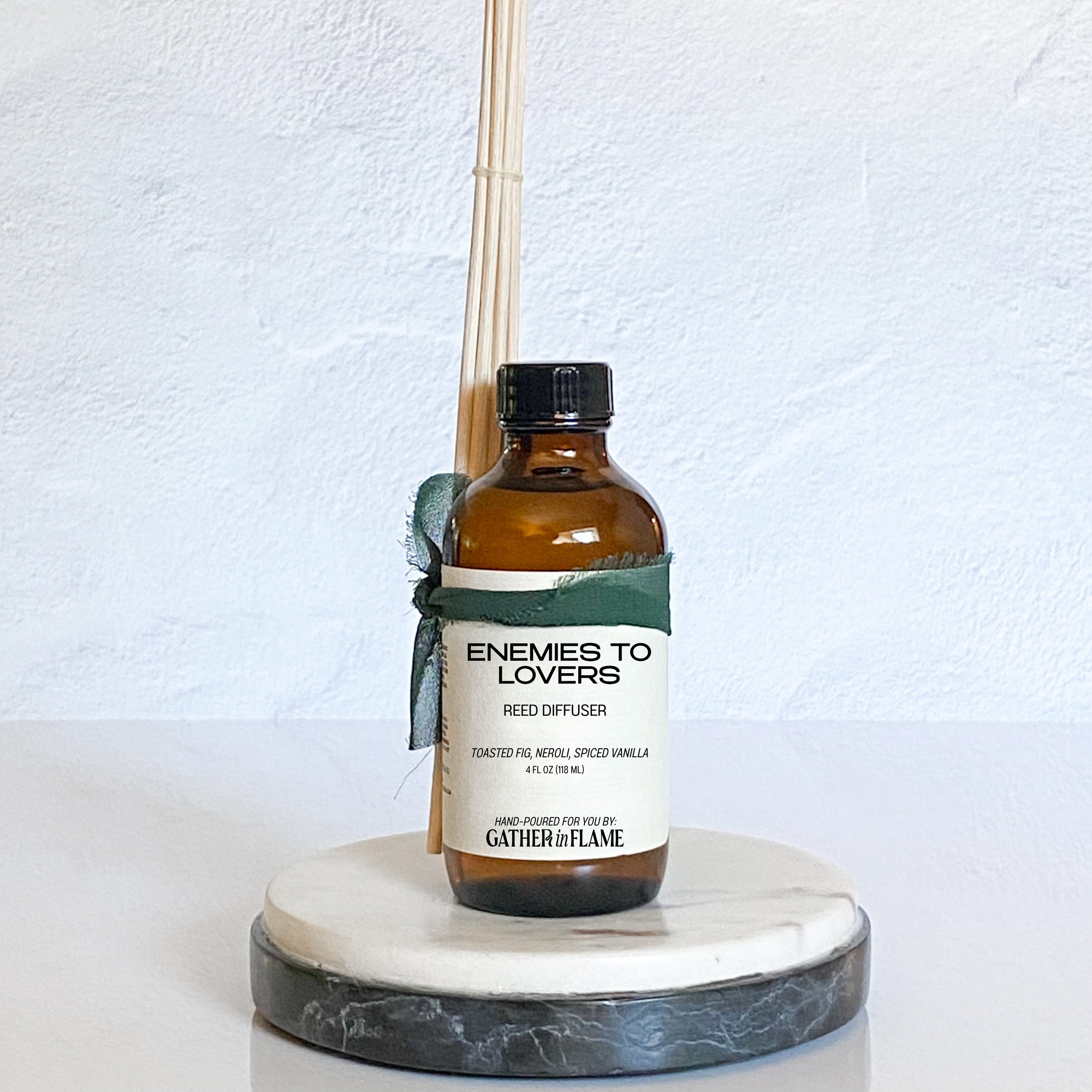 Reed diffuser labeled 'Enemies to Lovers' on a white background
