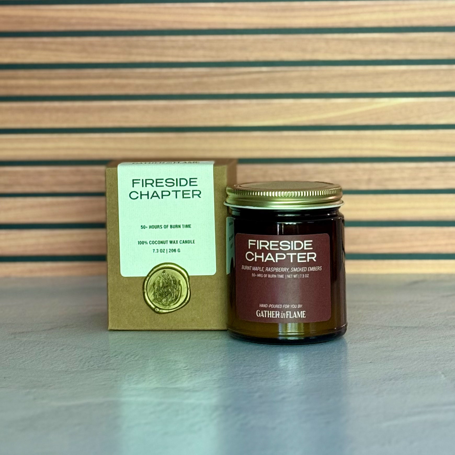 Fireside Chapter candle and packaging on a wooden surface
