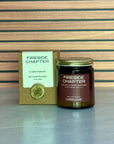 Fireside Chapter candle and packaging on a wooden surface