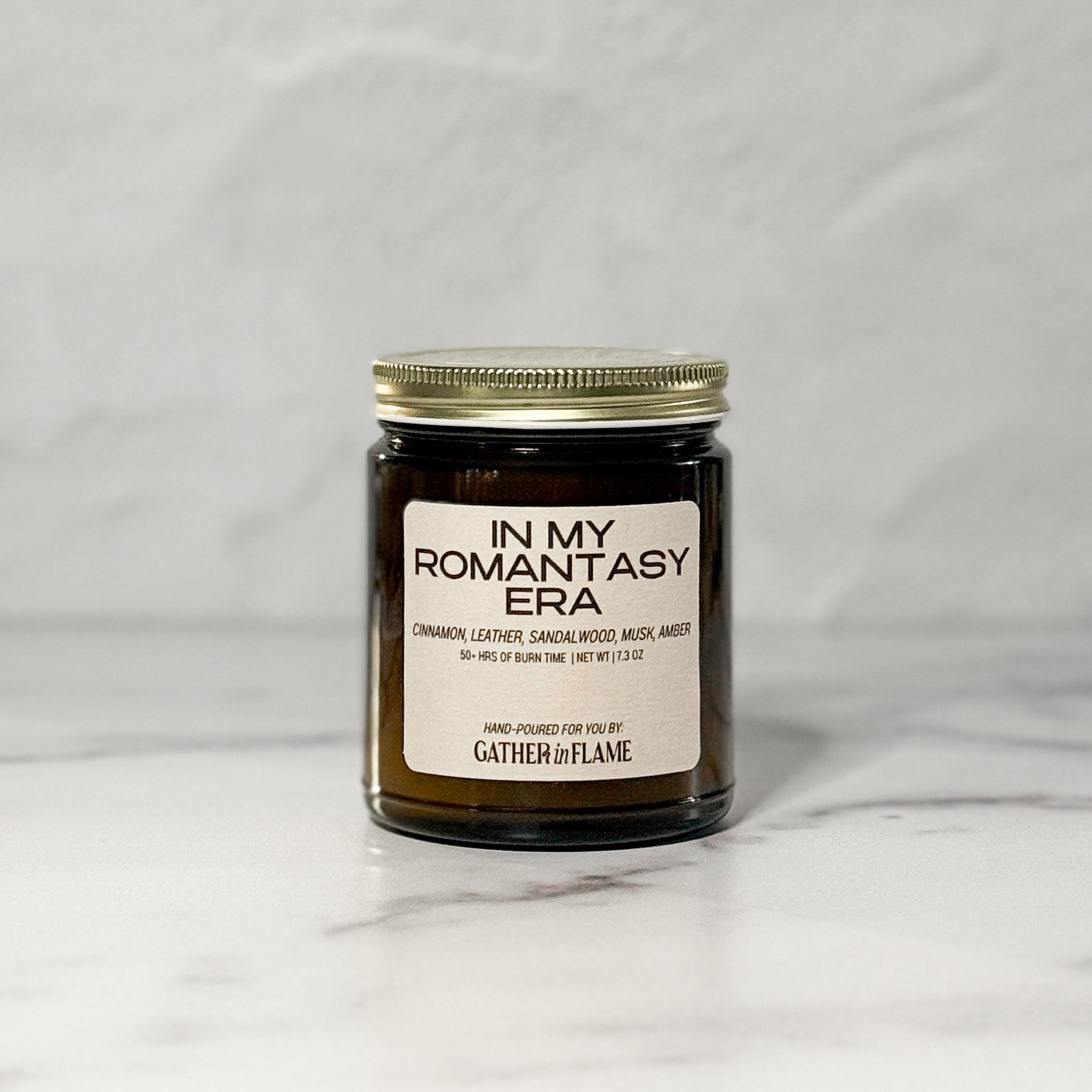 Amber glass jar candle labeled In My Romantasy Era facing forward with a white background.