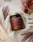Jar of 'Lavender Haze' candle with decorative elements on a soft surface