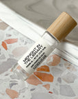 perfume roller labeled Midnight in the Library on a terrazzo surface