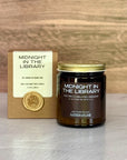 Candle labeled 'Midnight in the Library' with packaging on a wooden surface