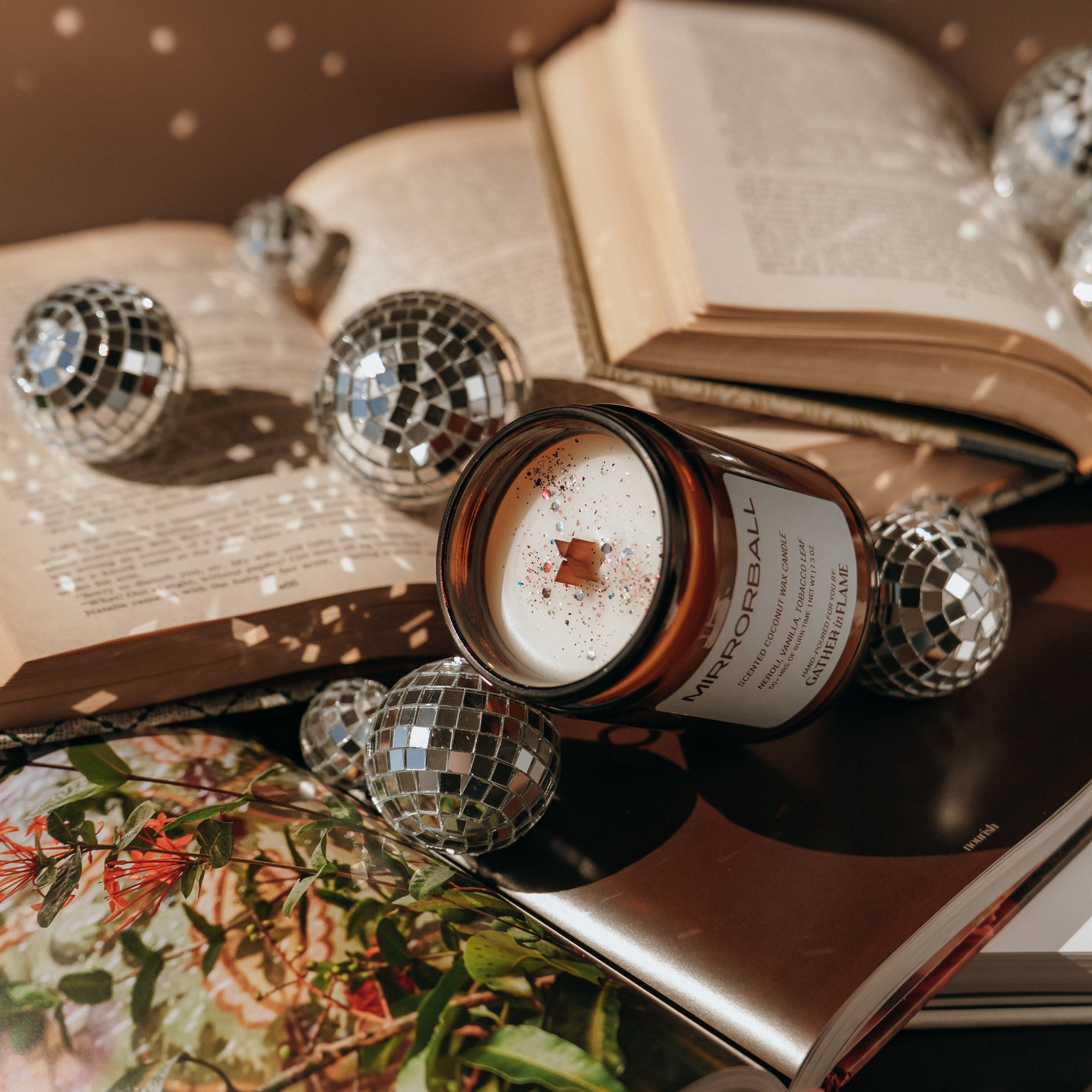 Candle with decorative elements on an open book