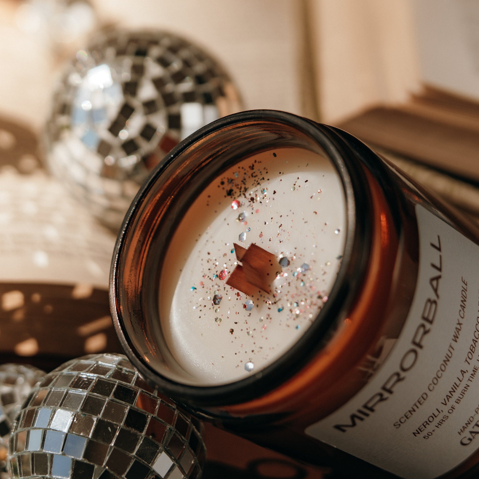 Candle with decorative label on a festive background