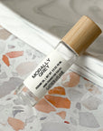 perfume roller labeled Morally Grey on a terrazzo surface