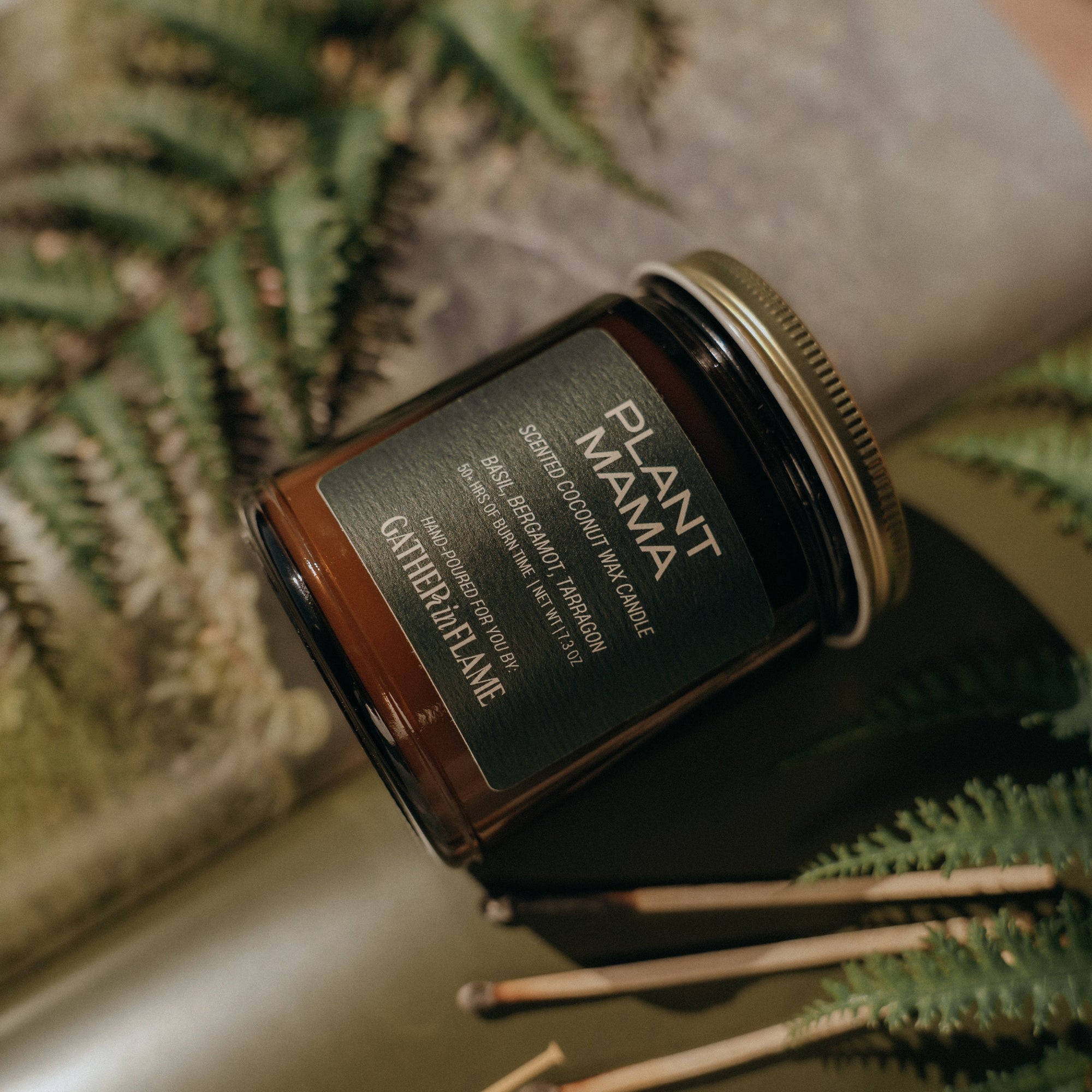 Jar of 'Plant Mama' candle with a decorative background