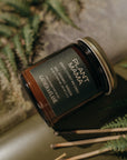 Jar of 'Plant Mama' candle with a decorative background