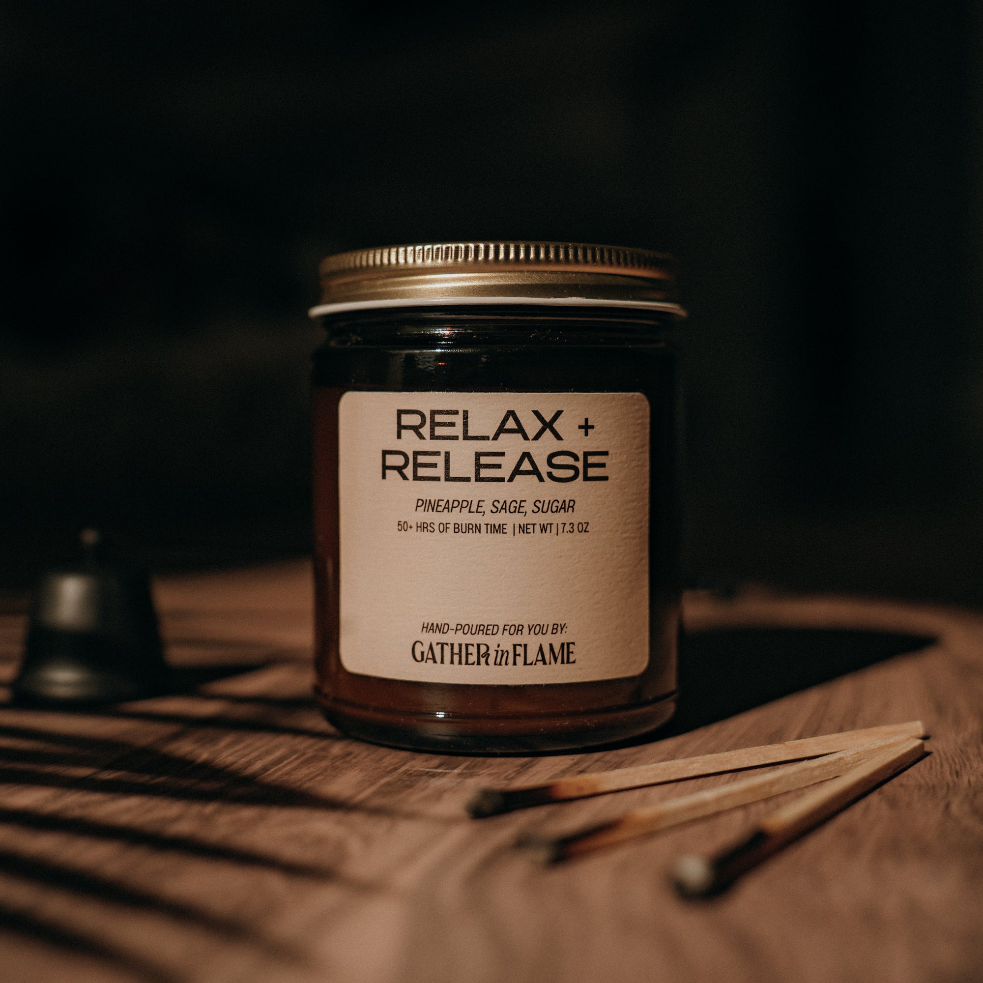 Jar labeled 'Relax + Release' on a wooden surface with a dark background