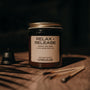 Jar labeled 'Relax + Release' on a wooden surface with a dark background