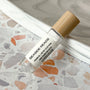 perfume roller labeled Seaside Reads on a terrazzo surface