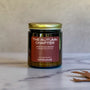 Candle labeled The Autumn Chapter on a light background