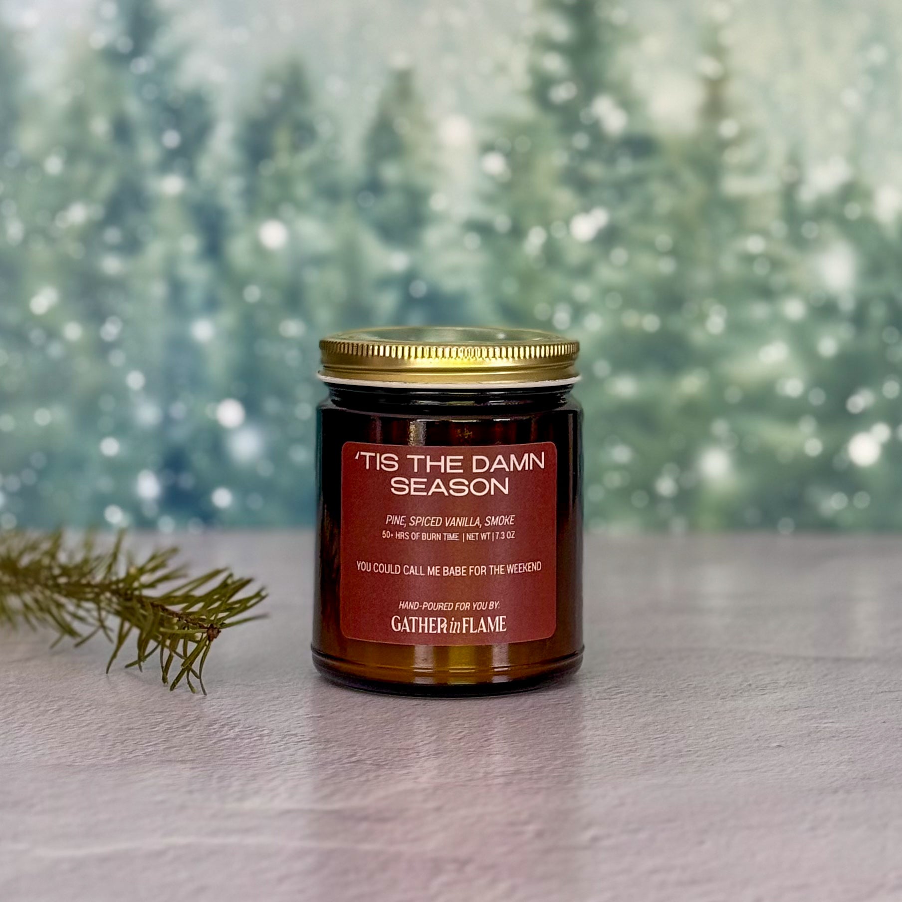 Candle jar labeled 'Tis the Damn Season with a festive background
